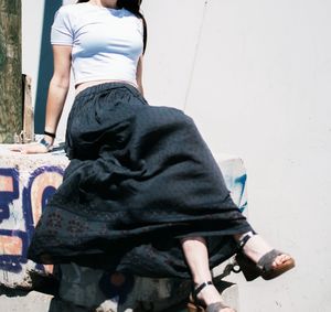 Rear view of woman sitting outdoors