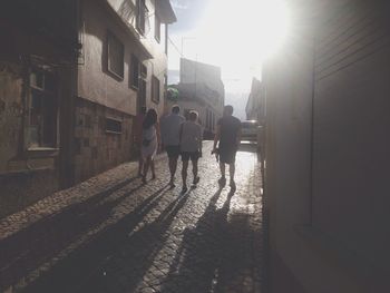 People walking on street during sunset