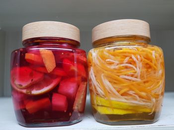 Fruits in jars on table