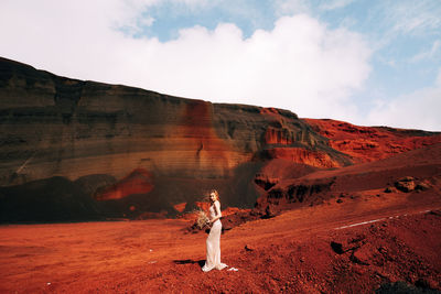 Scenic view of rock formations on land against sky