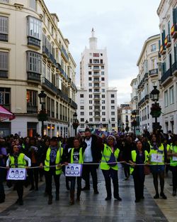 People in city against sky