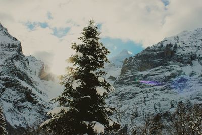 Scenic view of mountains against cloudy sky