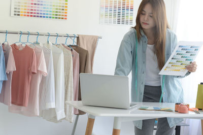 Portrait of young woman using laptop on table