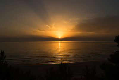 Scenic view of sea against romantic sky at sunset