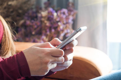 Midsection of woman using mobile phone