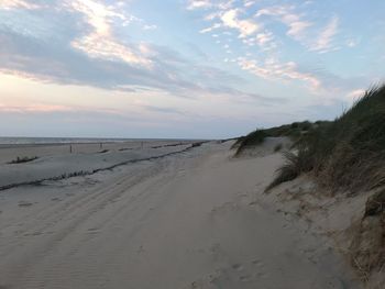 Scenic view of beach against sky during sunset