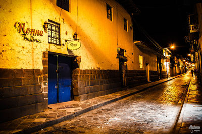 Illuminated street lights in city at night