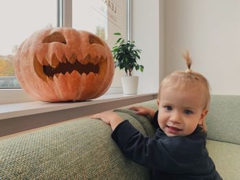 Portrait of a child with a jack lantern at home