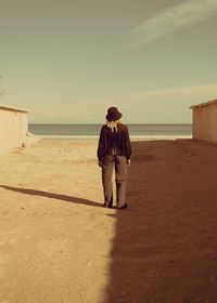 Rear view of couple standing on beach