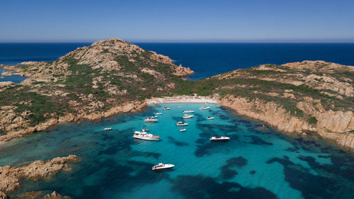 High angle view of boats sailing in sea against clear sky