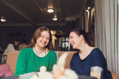 Two women talking and drinking coffee in cafe