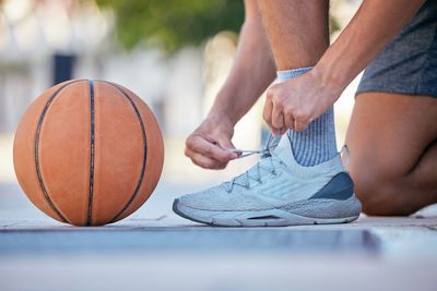 Midsection of man playing basketball