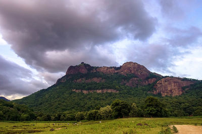 Scenic view of mountains against cloudy sky