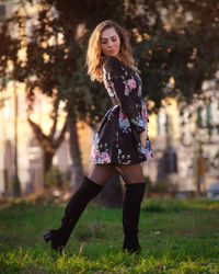 Portrait of beautiful young woman against plants