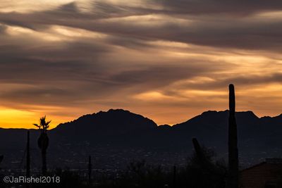 Scenic view of silhouette mountains against sky at sunset