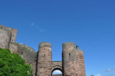 Low angle view of old building against blue sky