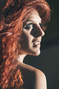 Close-up portrait of young woman looking away