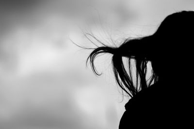Silhouette of woman's hair in wind