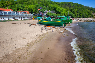 Boats moored on beach