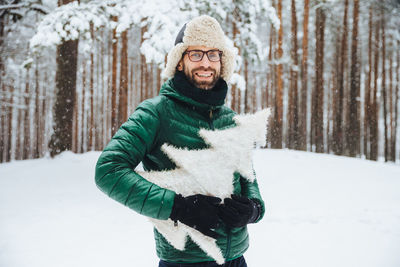 Portrait of woman standing in snow