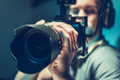 Close-up of man photographing with camera