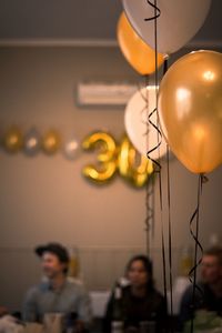 Close-up of balloons against illuminated lights