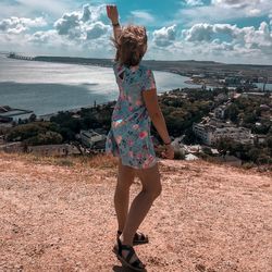 Rear view full length of woman looking at sea