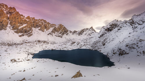 Scenic view of snowcapped mountains against sky during winter