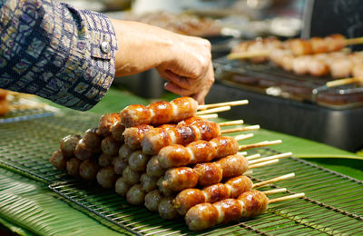 Cropped hand of woman holding food