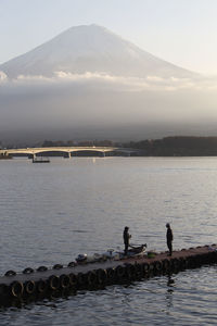 Scenic view of lake by mountain against sky