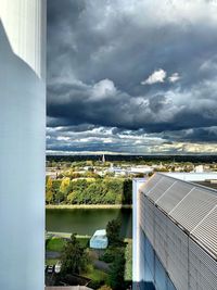 High angle view of buildings and river against sky