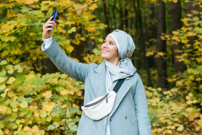 Full length of man photographing on mobile phone