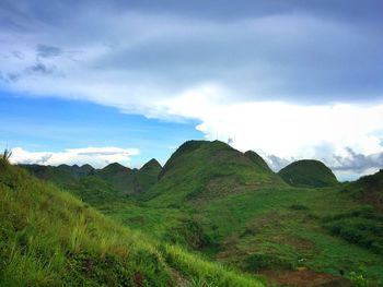 Scenic view of mountains against cloudy sky