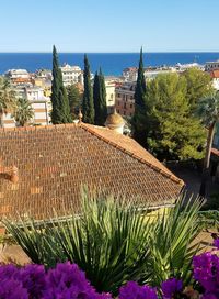 High angle view of town by sea against clear sky