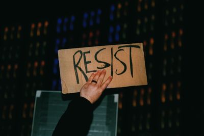 Close-up of hand holding text