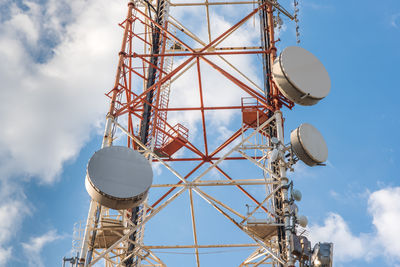 Low angle view of communications tower against sky