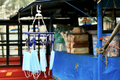 Surgical face masks are being hanged on a road side stall for sale.