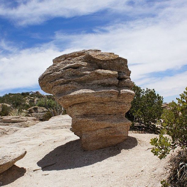 sky, rock formation, rock - object, cloud - sky, tranquility, tranquil scene, nature, cloud, scenics, beauty in nature, day, sunlight, low angle view, landscape, geology, outdoors, rock, non-urban scene, stone, no people