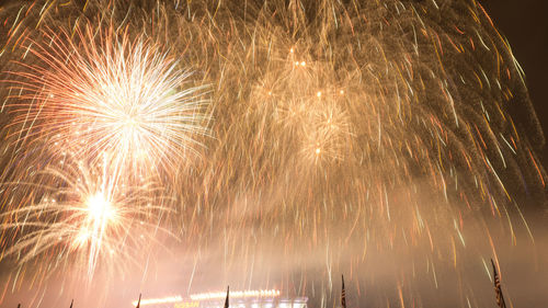 Low angle view of fireworks against sky at night