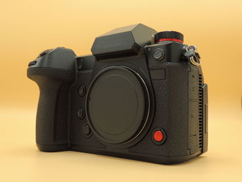 Close-up of camera on table against white background