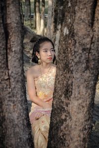 Girl in traditional clothing sitting at park