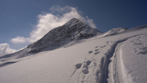 Scenic view of snow covered mountains against sky