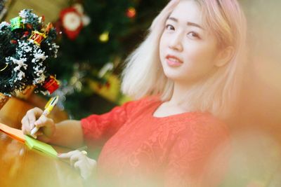 Portrait of a girl holding christmas tree