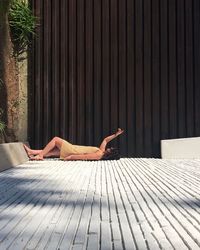 Woman lying on wooden floor