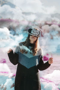 Portrait of smiling young woman standing on snow