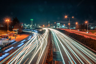 High angle view of light trails on road at night