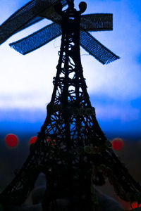 Silhouette of tower against cloudy sky