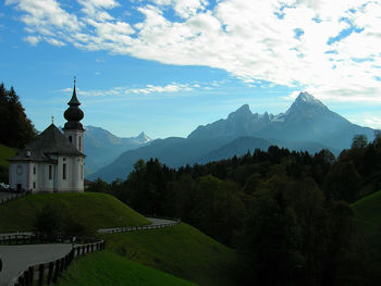 Scenic view of building and mountains against sky