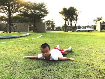 Girl lying on grassy field