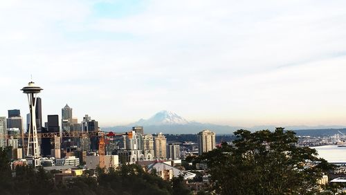 View of cityscape against cloudy sky